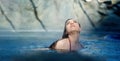 Portrait of beautiful mature woman with dark hair relaxes contend happy in holidays summer sun in the blue spa wellness whirlpool Royalty Free Stock Photo