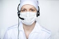 Portrait of a beautiful medical woman wearing protective mask with handset