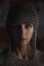 Portrait of beautiful medieval girl warrior in a chainmail hood.