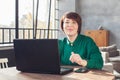 Portrait of beautiful mid adult woman working laptop computer indoors Royalty Free Stock Photo