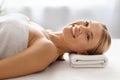 Beautiful middle aged woman comfortably lying on a table at spa salon Royalty Free Stock Photo