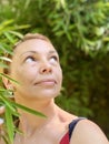 Portrait of a beautiful middle-aged woman in a greenhouse. Royalty Free Stock Photo