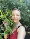 Portrait of a beautiful middle-aged woman in a greenhouse. Royalty Free Stock Photo