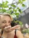 Portrait of a beautiful middle-aged woman in a greenhouse. Royalty Free Stock Photo