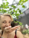 Portrait of a beautiful middle-aged woman in a greenhouse. Royalty Free Stock Photo