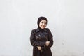 Portrait of beautiful middle-eastern girl in traditional Islamic clothing - hijab. Modern and young Iranian woman in leather