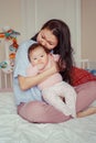 Asian mother kissing touching embracing her cute adorable newborn infant baby. Royalty Free Stock Photo