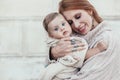 Mom and baby dressed in warm winter knitted clothing