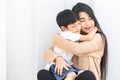 Portrait beautiful mother and child happily hugged. Asian family mom and child are hugging and closing their eyes, cute and warm