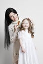 Portrait of a beautiful mother and daughter in his arms on a white background