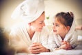 Portrait of beautiful mother and daughter looking etch other.