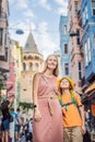 Portrait of beautiful mother and son tourists with view of Galata tower in Beyoglu, Istanbul, Turkey. Turkiye. Traveling