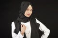 Portrait of a beautiful Muslim woman in modern oriental clothes on an isolated black background