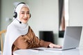 Portrait of beautiful Muslim women wearing hijab customer support phone operator at workplace. Professional operator concept Royalty Free Stock Photo