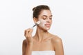 Portrait beautiful naked woman apply cosmetic white clay mask on with brush. Isolated on a white background. concept of Royalty Free Stock Photo