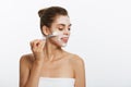 Portrait beautiful naked woman apply cosmetic white clay mask on with brush. Isolated on a white background. concept of Royalty Free Stock Photo