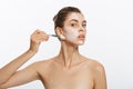 Portrait beautiful naked woman apply cosmetic white clay mask on with brush. Isolated on a white background. concept of Royalty Free Stock Photo