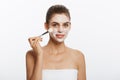 Portrait beautiful naked woman apply cosmetic white clay mask on with brush. Isolated on a white background. concept of Royalty Free Stock Photo