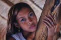 Portrait of a beautiful native Asian girl climbing on the sunshade umbrella