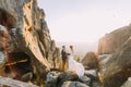 Portrait of beautiful newlywed couple in bright sunset lights on majestic mountain landscape with big rocks as backround Royalty Free Stock Photo