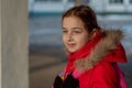 Portrait of a beautiful nine year old little girl. School child in winter clothes on the street. Girl 9 years old