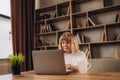 Portrait of beautiful older woman working laptop computer indoors Royalty Free Stock Photo