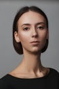 Portrait of a beautiful pacified woman in a black blouse and with medium short hair. Studio photo session