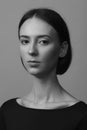 Portrait of a beautiful pacified woman in a black blouse and with medium short hair. Studio photo session