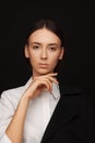 Portrait of a beautiful pacified woman in a white shirt and black jacket. Studio photo session