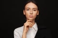 Portrait of a beautiful pacified woman in a white shirt and black jacket. Studio photo session