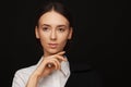 Portrait of a beautiful pacified woman in a white shirt and black jacket. Studio photo session