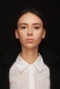 Portrait of a beautiful pacified woman in a white shirt and black jacket. Studio photo session