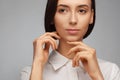 Portrait of a beautiful pacified woman in a white shirt on a light background Royalty Free Stock Photo