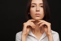 Portrait of a beautiful pacified woman in a white shirt on a light background Royalty Free Stock Photo