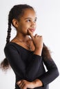 Portrait of a beautiful pensive dark-skinned girls on a white background. the baby thinks.