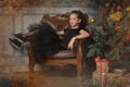 Portrait of a beautiful pensive girl in black near the Christmas tree at Christmas Royalty Free Stock Photo