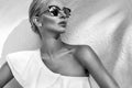 Portrait beautiful phenomenal stunning elegant blonde model woman with perfect face wearing a sunglasses and elegant white sw