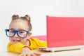 Portrait of beautiful playful little girl with glasses using laptop computer Royalty Free Stock Photo