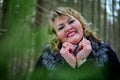 Portrait of beautiful plump woman in a nice winter forest