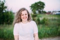 Portrait Of Beautiful Plus Size Young Woman In White Shirt Posing In Summer Field Meadow At Sunset Background Royalty Free Stock Photo