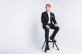 Portrait of the beautiful posing in a Studio, White background, Stylish business man, Stylish man sitting on a designer chair Royalty Free Stock Photo