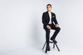 Portrait of the beautiful posing in a Studio, White background, Stylish business man, Stylish man sitting on a designer chair Royalty Free Stock Photo