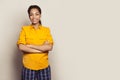 Portrait of beautiful positive african american woman standing with arms crossed against white studio wall background Royalty Free Stock Photo