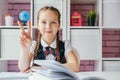 Portrait beautiful little schoolgirl sitting at her desk. Back to school concept