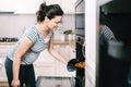 Portrait of beautiful pregnant wife preparing pizza and cooking dinner Royalty Free Stock Photo