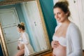 Portrait of a beautiful pregnant woman in front of a mirror at home Royalty Free Stock Photo