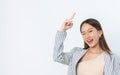 Portrait of a Beautiful and Professional Asian Business Woman Cheerfully Smiling and Pointing Up Royalty Free Stock Photo