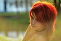 Portrait of beautiful red-hair woman on the natural background with sunshine backlight Royalty Free Stock Photo