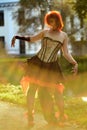 Portrait of beautiful red-hair woman on the natural background in Victorian suit Royalty Free Stock Photo