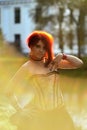 Portrait of beautiful red-hair woman on the natural background in Victorian suit Royalty Free Stock Photo